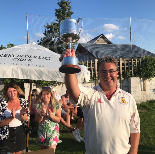 Steve Cole raises the trophy aloft